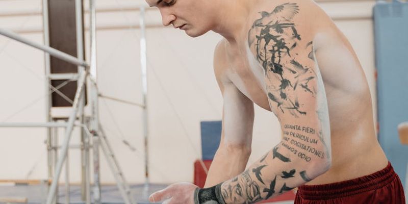 Shadowy figure of a man performing a strength exercise.